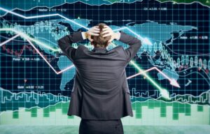 A stock market trader holds his head in despair during a stock market crash