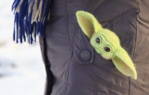 A baby yoda toy indicates the current success of the Disney+ streaming platform.